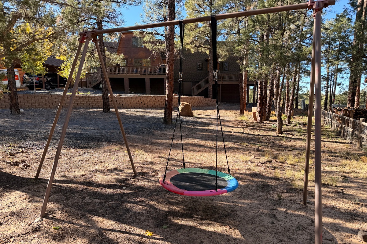 Backyard swing set at Poppywood Pines nestled beneath towering pines in Arizona’s White Mountains 🌲 A family-friendly cabin retreat in Show Low featuring open forest space, fresh mountain air, and room to play—where kids laugh, memories are made, and cabi