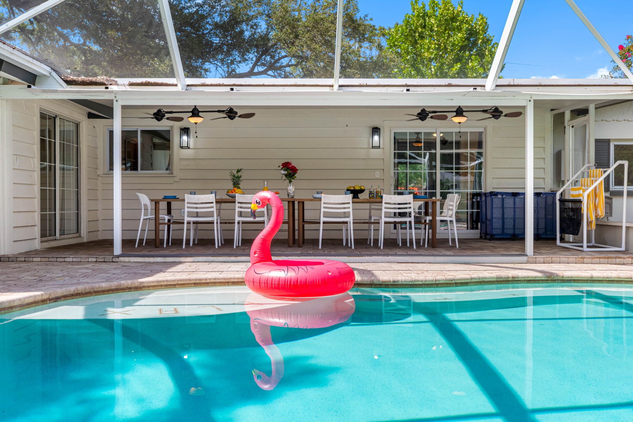 Covered lanai connects seamlessly to the pool for indoor-outdoor living.