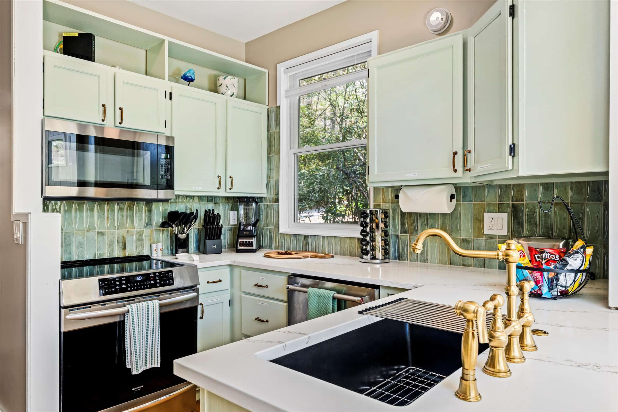 Modern touches include quartz counters, induction stove, dishwasher, and disposal.