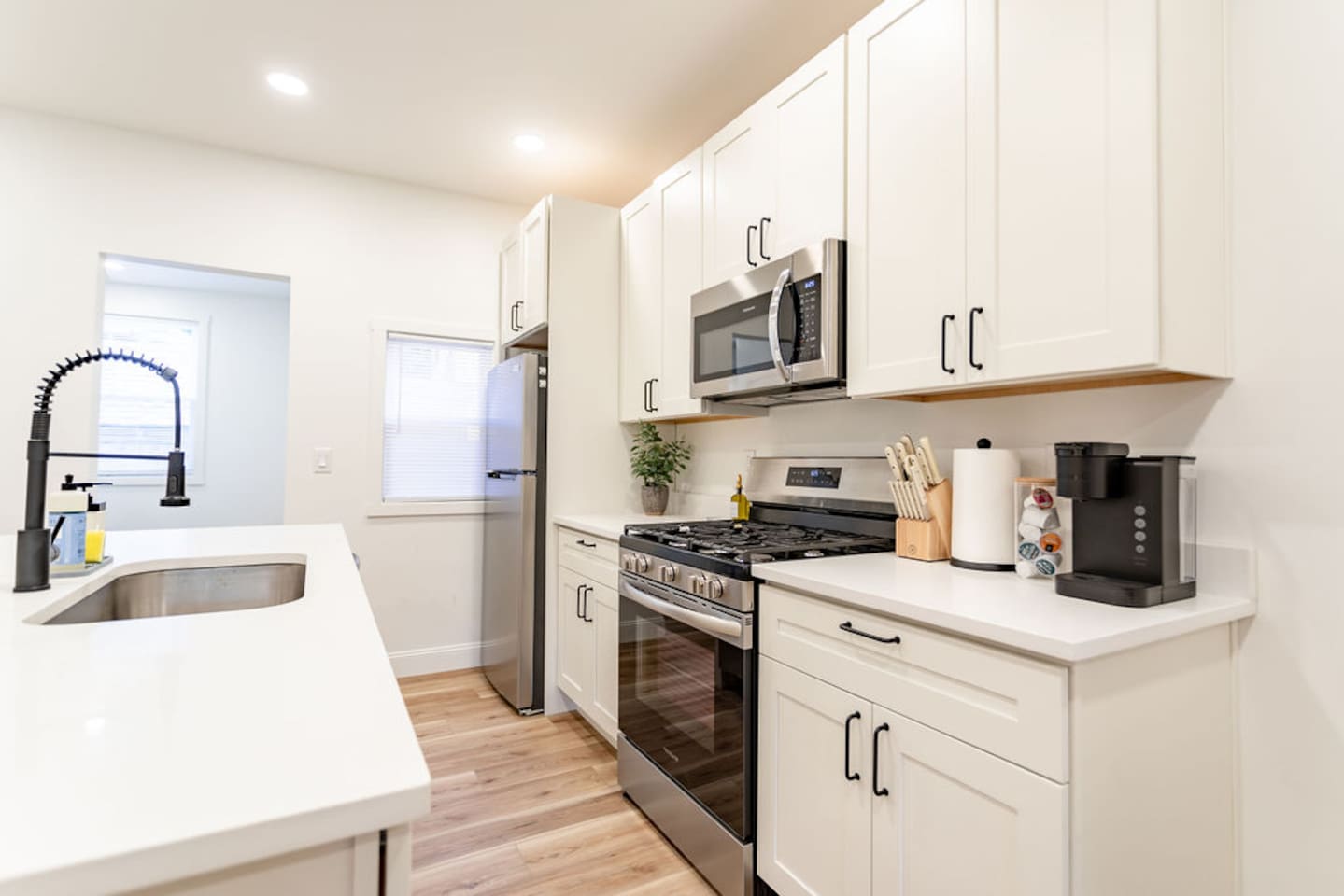 Bright and inviting kitchen view, featuring modern appliances and plenty of space for cooking.
