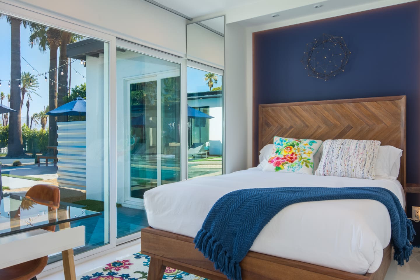 Bedroom 2 with slider direct to pool deck and custom parota wood barn door