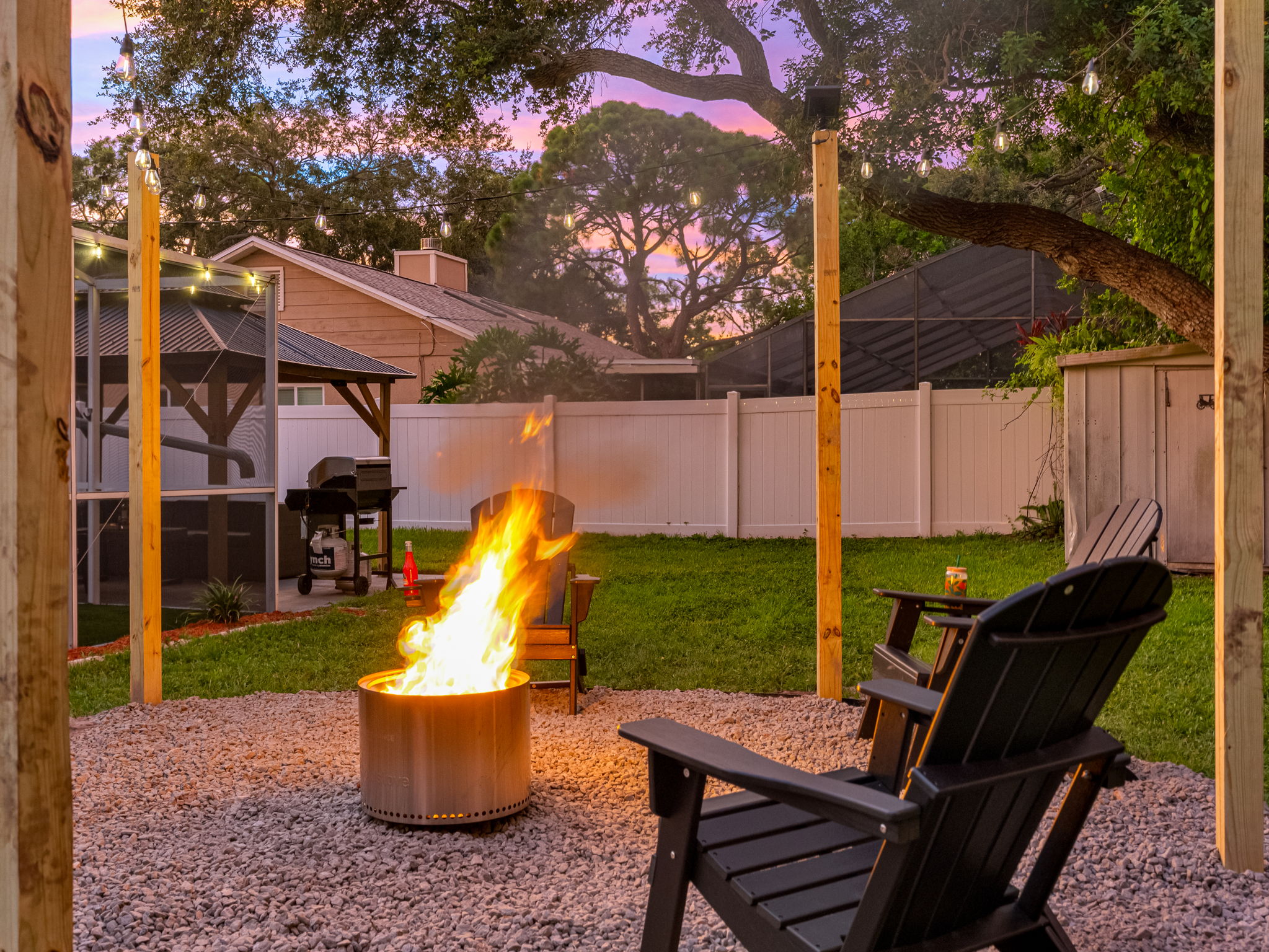 Unwind with a drink, roast some treats, and enjoy the night sky from this welcoming, beautifully lit fire pit corner.