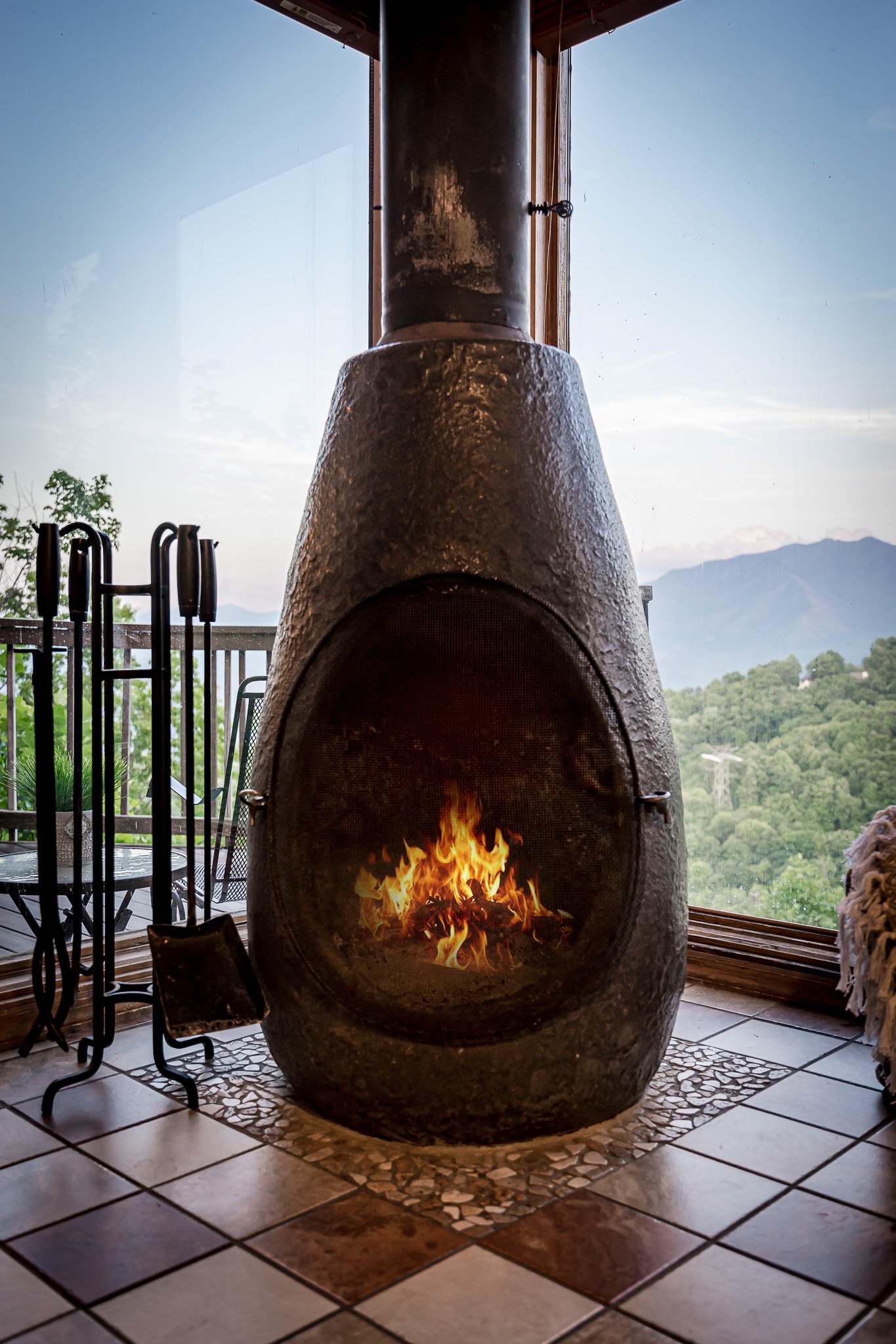 Unique pot belly stove located in the main living room featuring amazing views from the windows behind