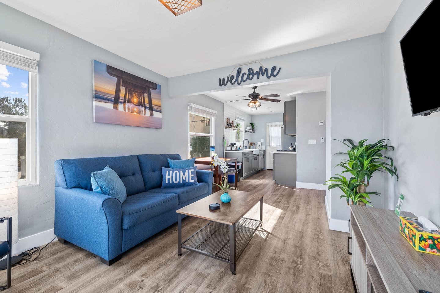 Unwind in a beautifully decorated living room with an elegant sofa bed, TV, indoor plants, and a scenic window view. A perfect blend of style and comfort awaits you!