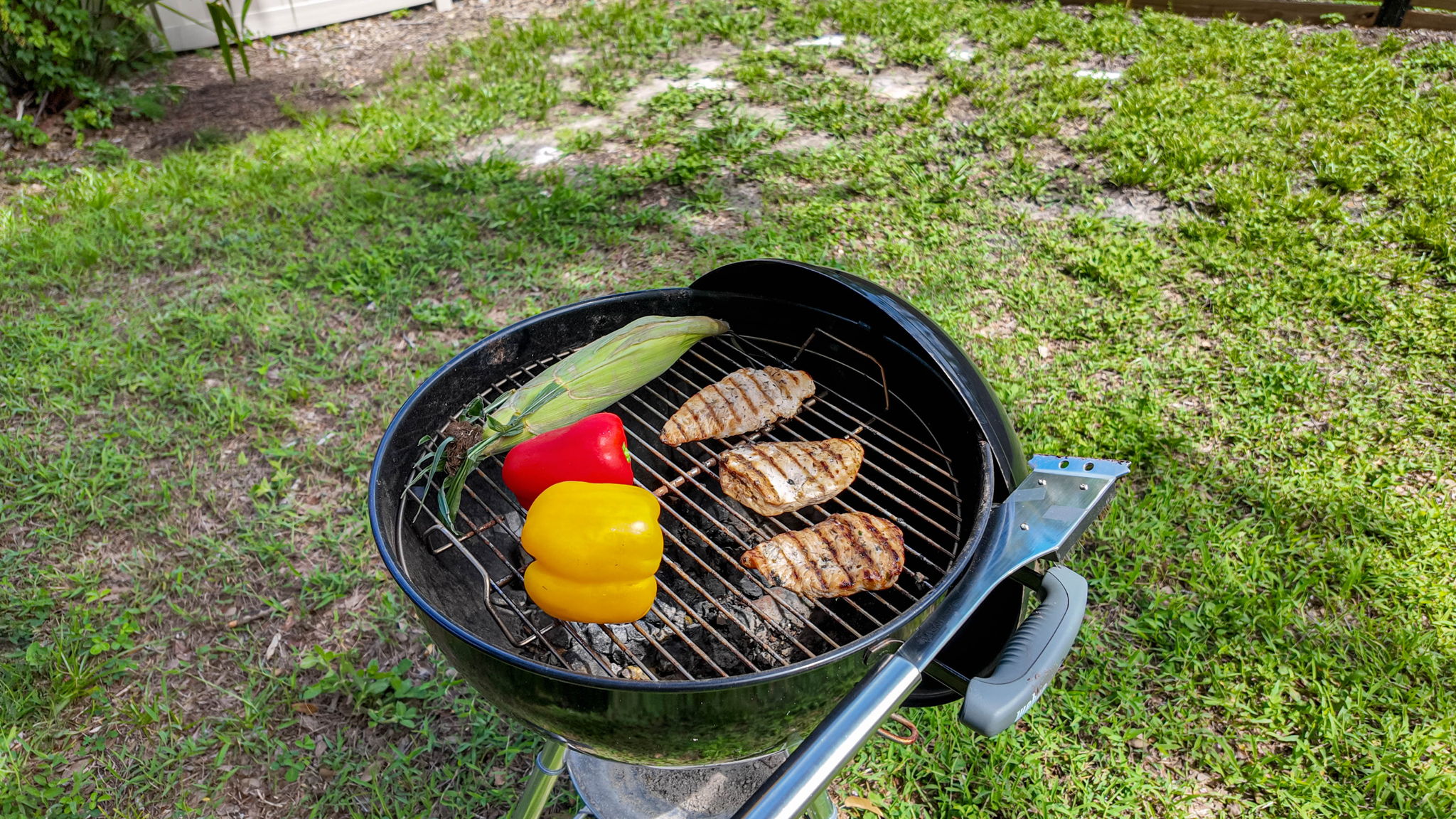 A classic charcoal kettle BBQ sits ready for your grilling adventures.
