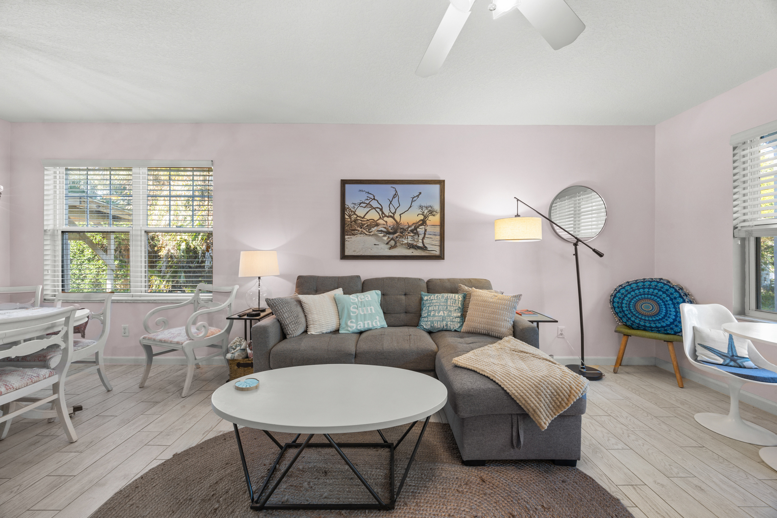 Bright and inviting living room with comfortable seating and natural light — perfect for relaxing after a day at the beach.