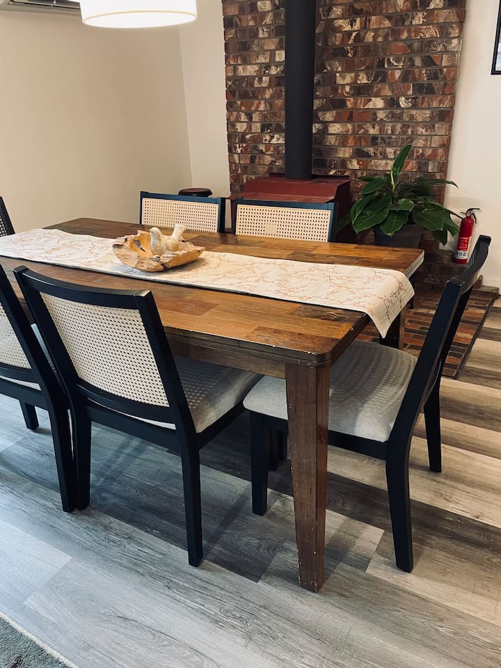 A warm dining space where light and form come together, inviting shared meals and quiet moments around the table.