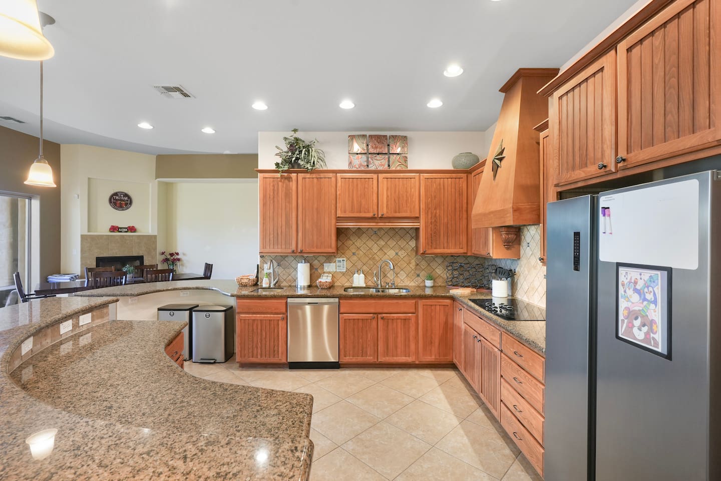 Fully equipped kitchen with stainless steel appliances and generous counter space.