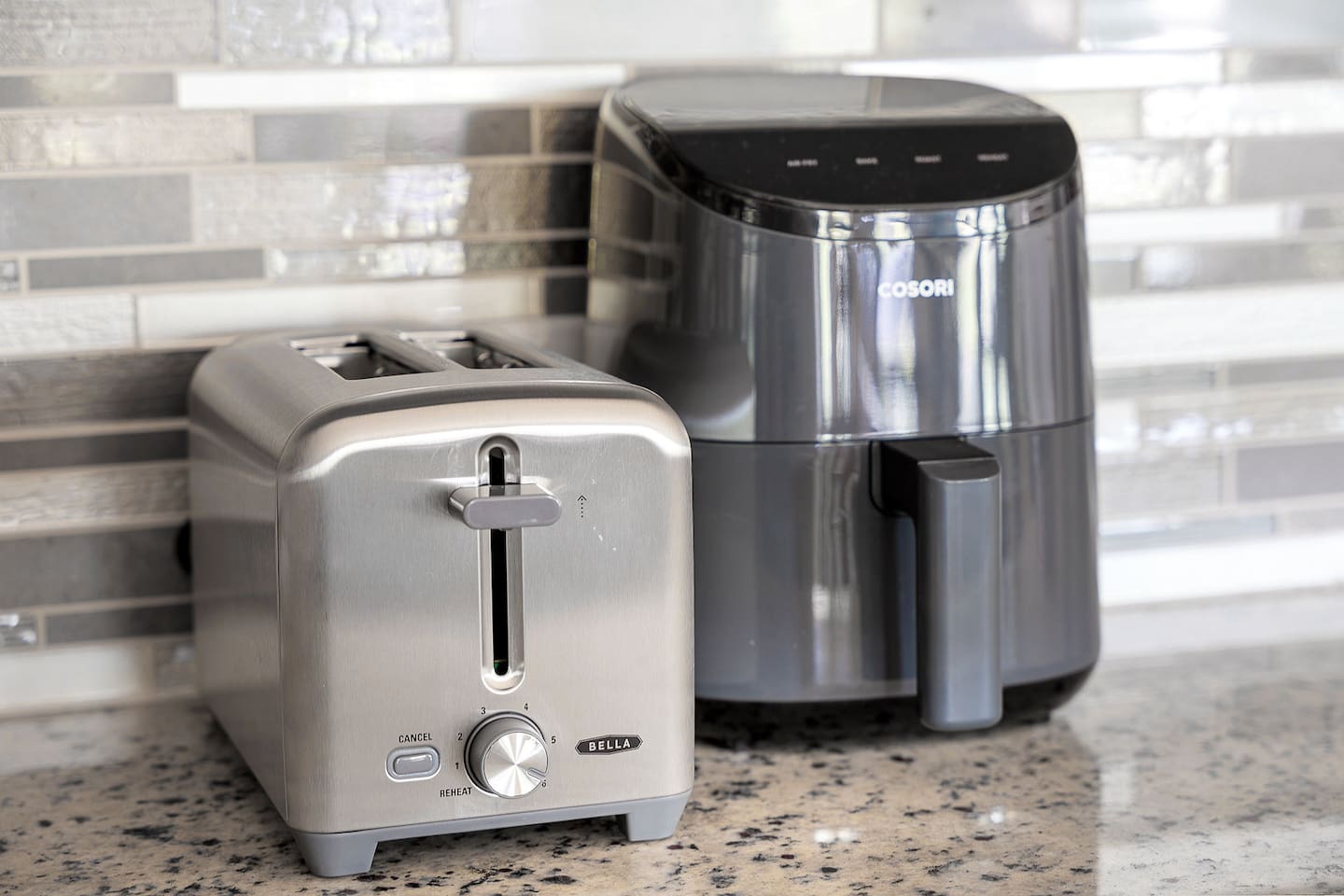 Discover a well-equipped kitchen featuring a sleek toaster and a modern air fryer, enhancing your cooking experience.