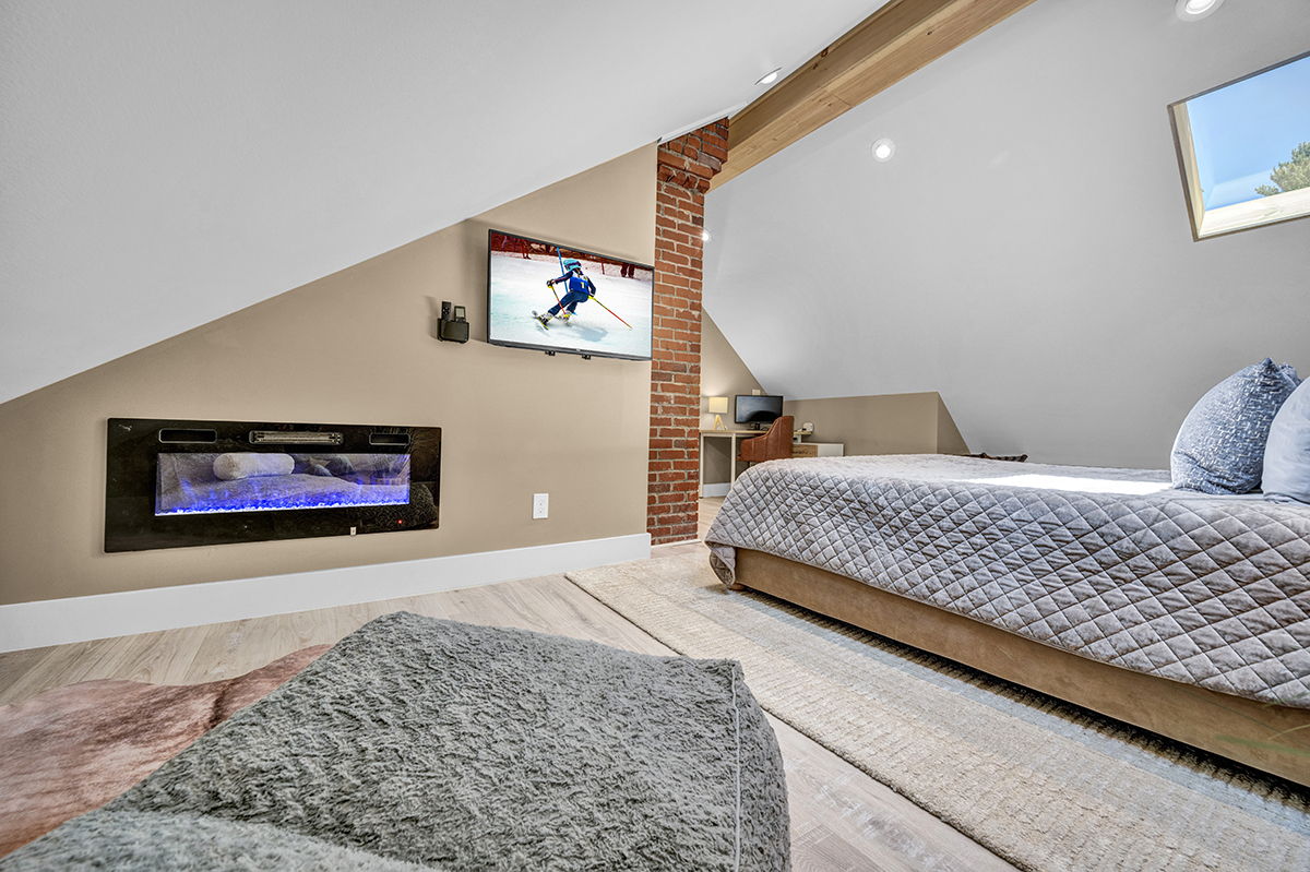 Master Bedroom with King Bed, 42-inch Smart TV, Fireplace, sound machine, blackout curtains and cozy reading chair