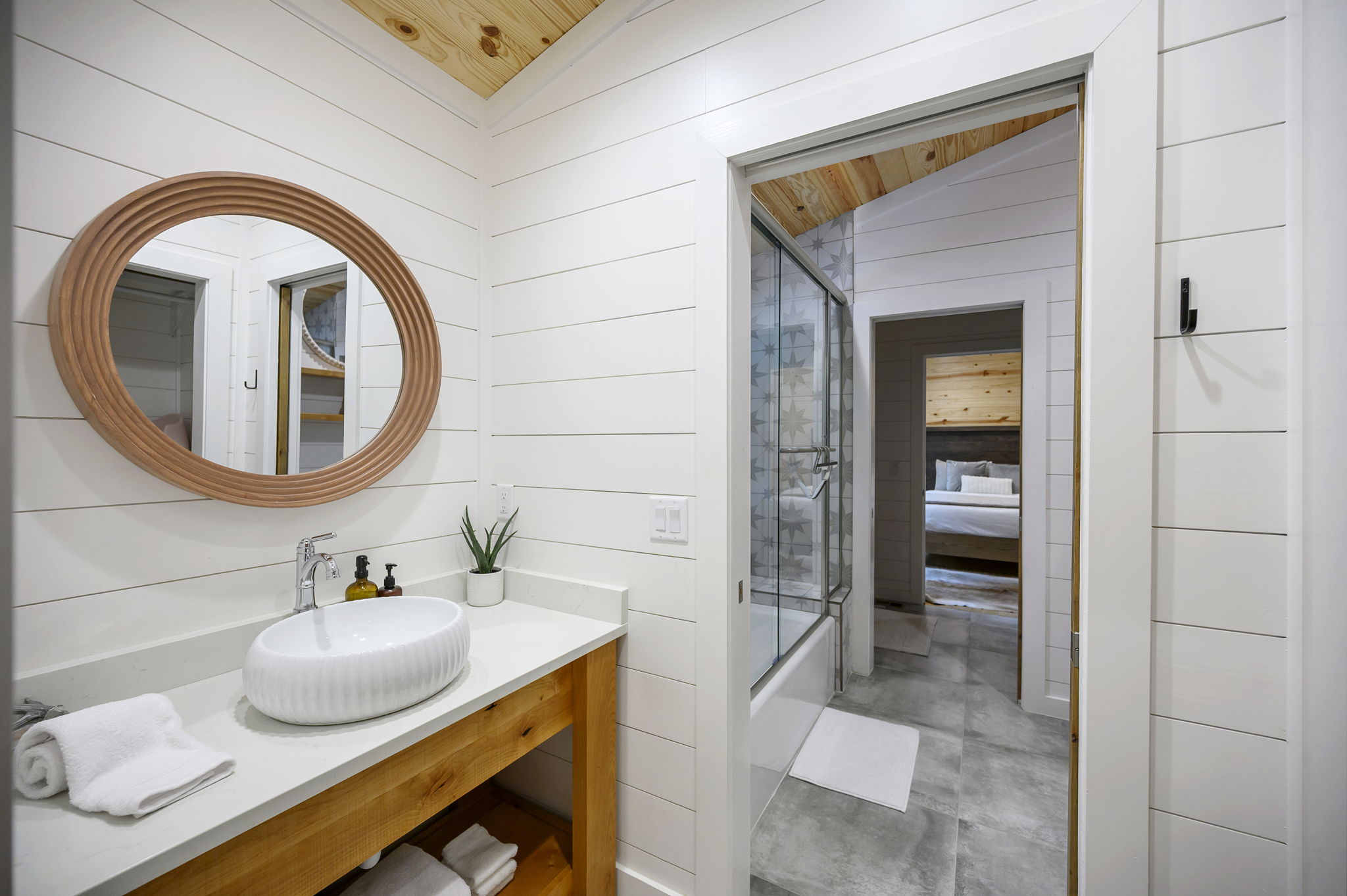 The shared full bathroom offers a cozy, spa-like feel with luxury finishes, warm design details, and everything guests need to feel comfortable and refreshed.