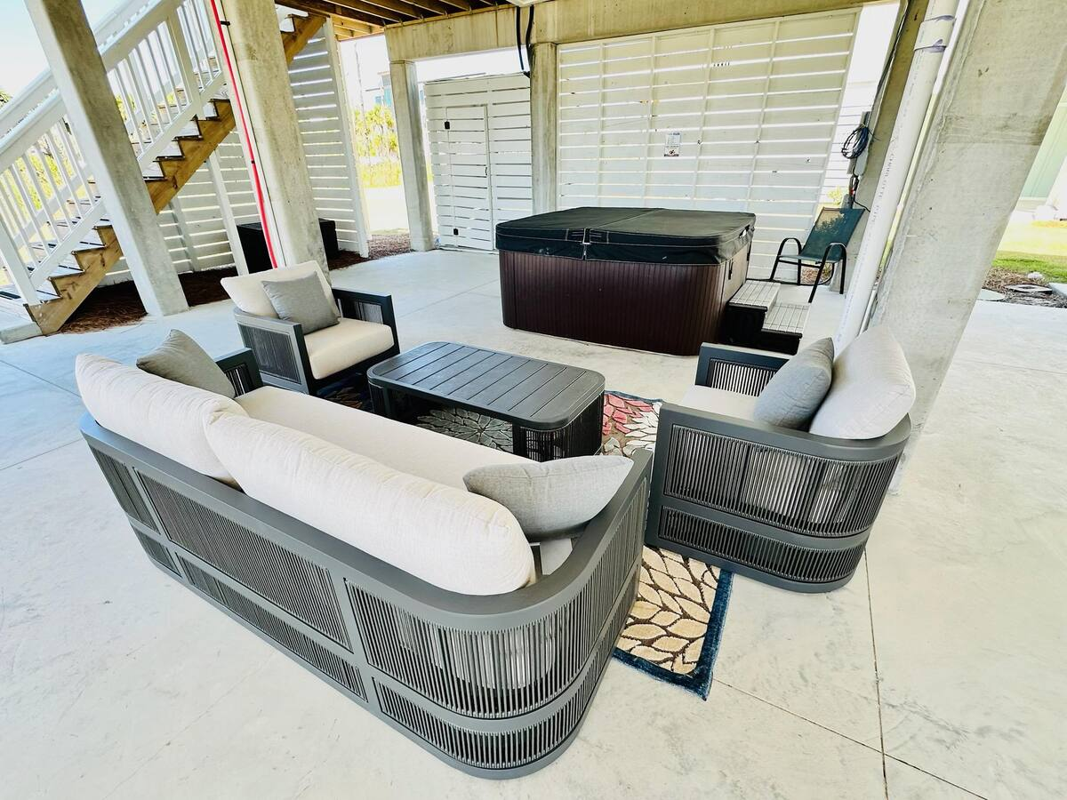 Relax on the cozy patio with comfortable seating, perfect for morning coffee, evening cocktails, or unwinding after a day at the beach.