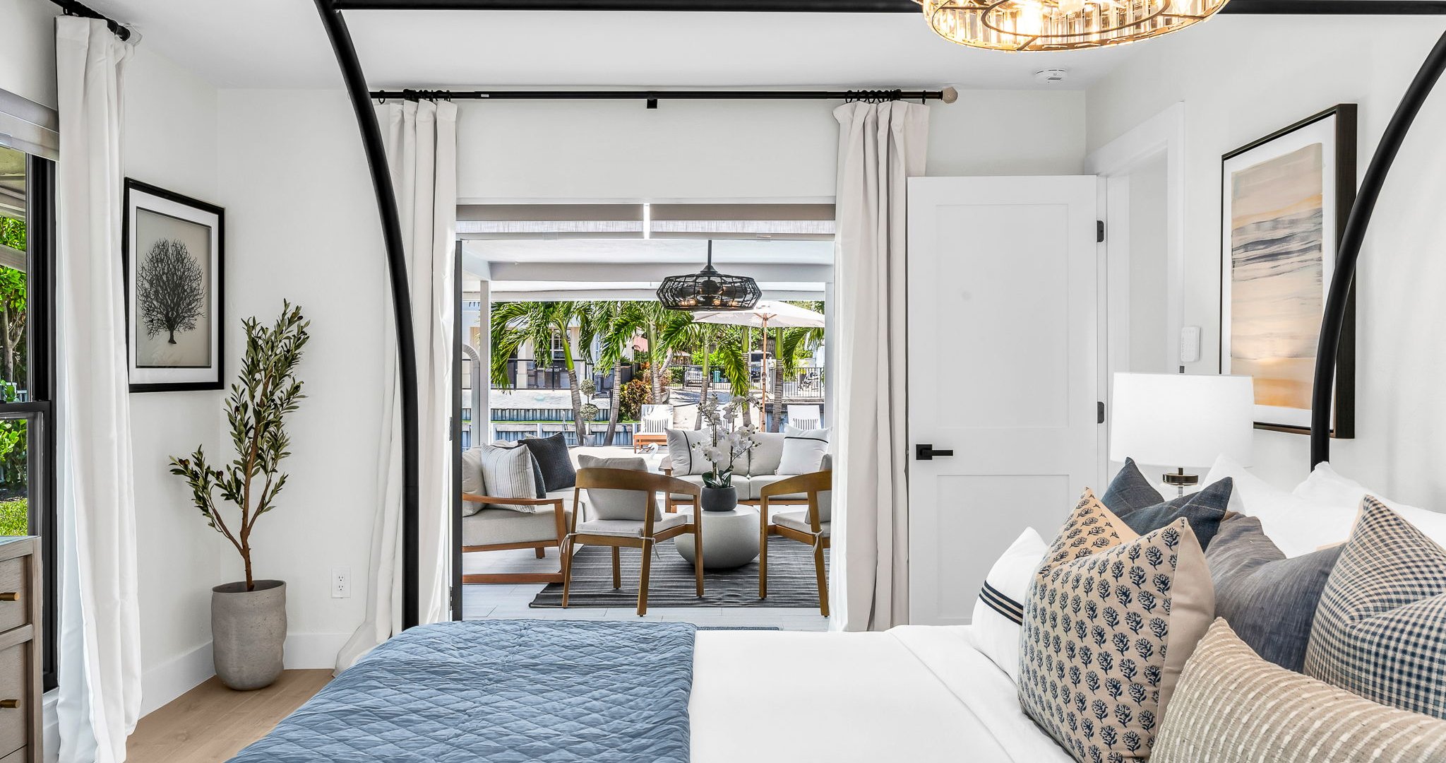 This second primary suite offers a plush king bed, private ensuite bathroom, and walk-in closet for added comfort. Enjoy poolside views and direct access to the outdoor living area, making it the perfect blend of luxury and convenience.
