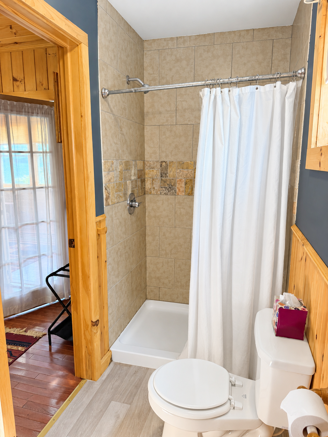 Spacious bathroom with tiled shower