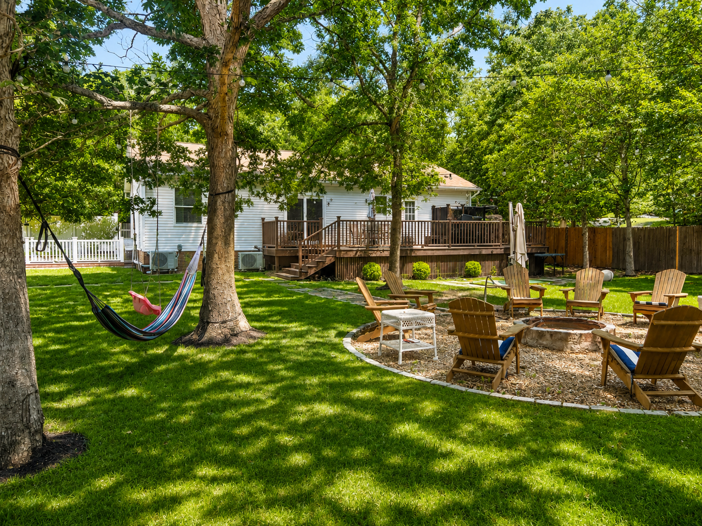Firepit lounge with hammocks and Adirondack chairs
