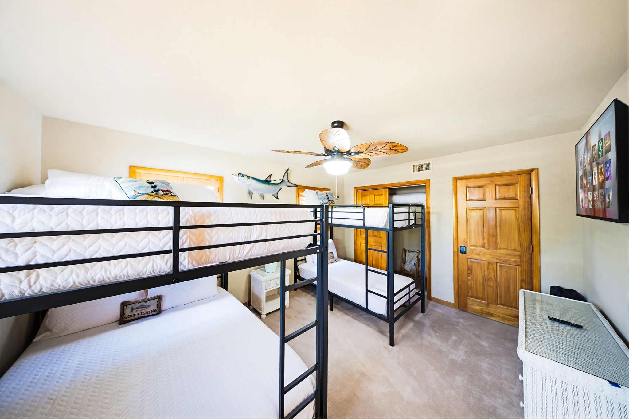 The bunk room includes queen bunk beds and twin bunk beds, and like every bedroom in the house, has a TV.