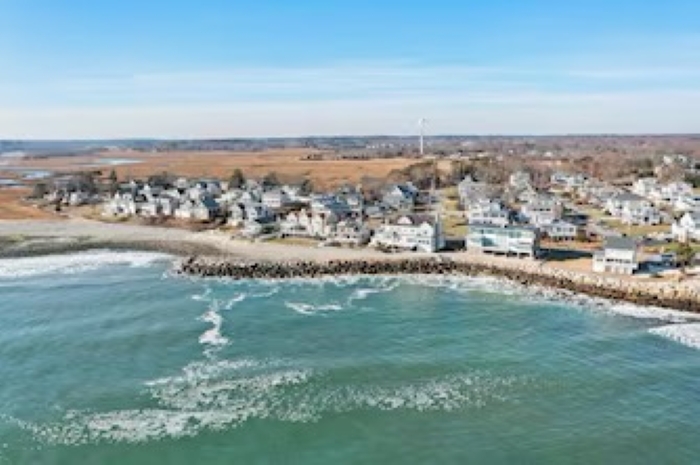 Bird’s-eye view of the house, backyard, and beautiful coastal setting.