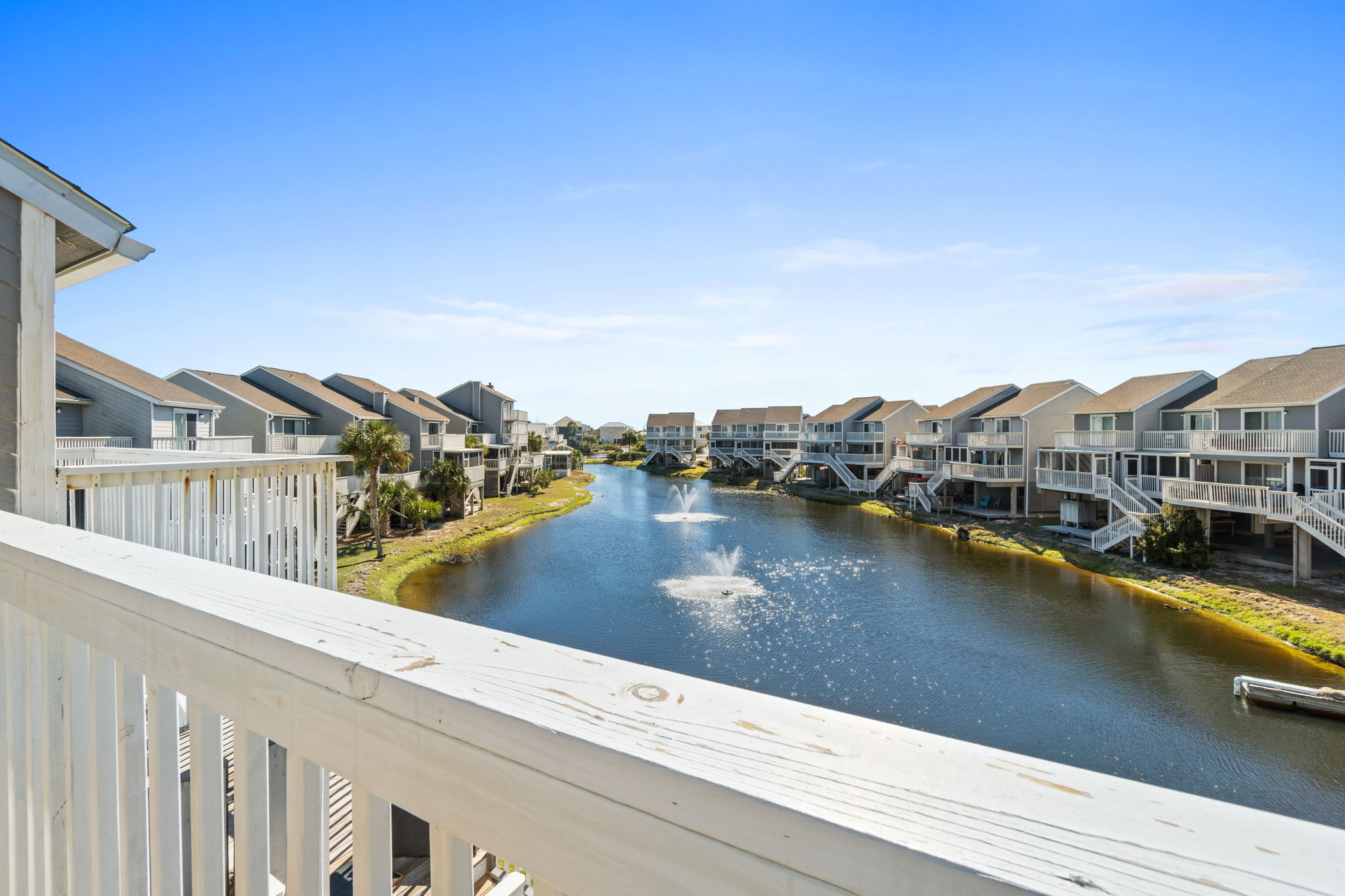 Primary bedroom balcony overlooks pond/fountain
