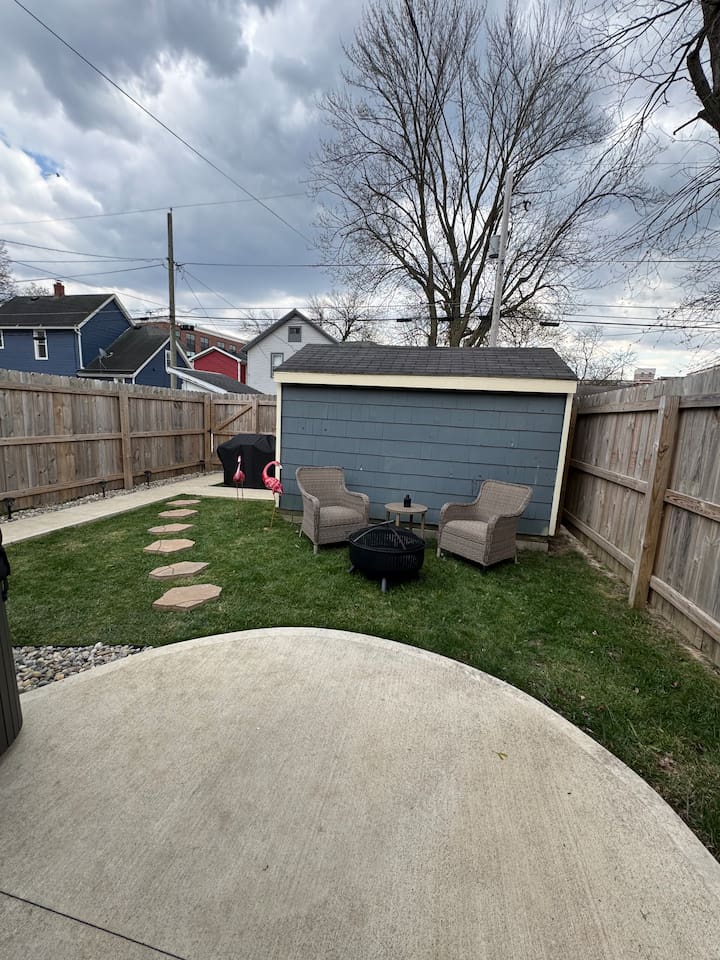 Cozy backyard retreat featuring a fire pit with comfortable outdoor seating—perfect for evening conversations and relaxing under the stars.