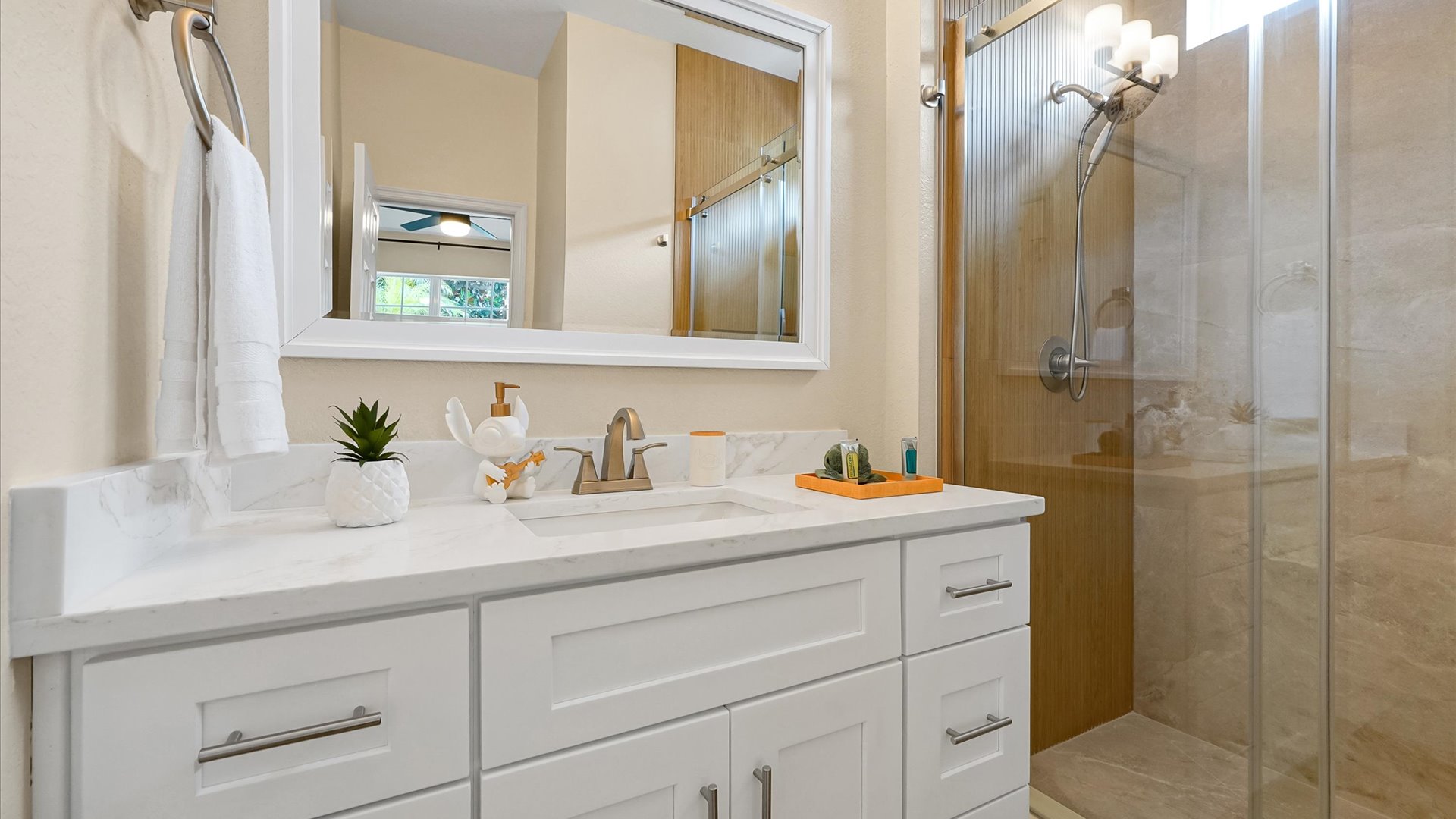 Stitch Queen Retreat Ensuite: Renovated private ensuite with a bright vanity and custom-tiled walk-in shower.