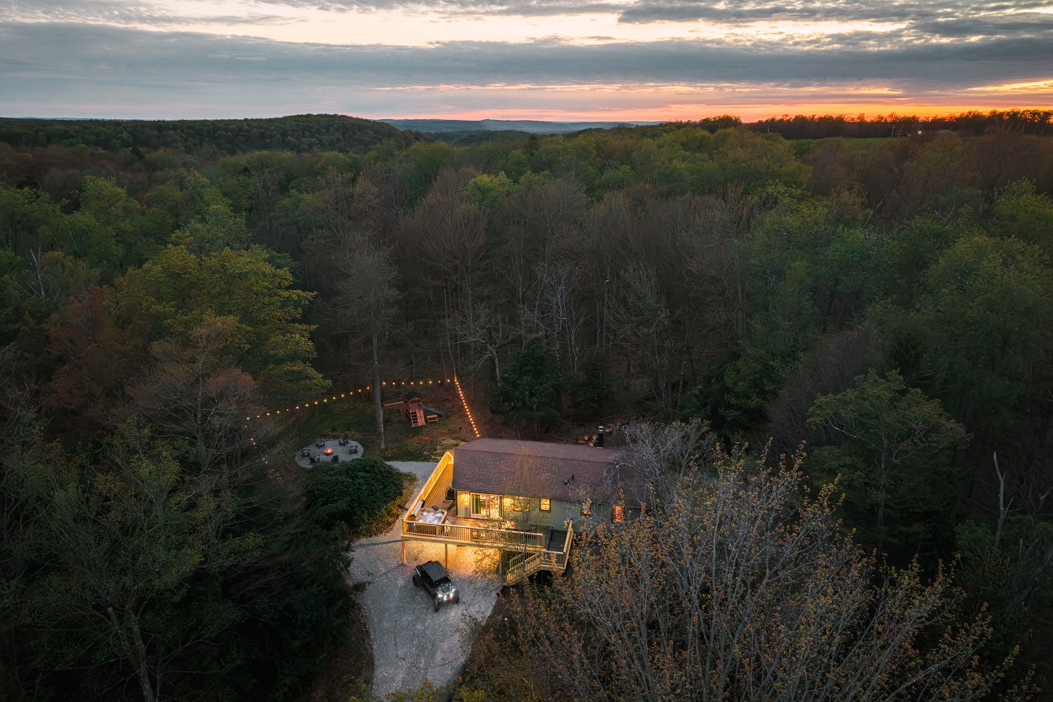 🏡 The cabin aglow beneath a fiery sky.