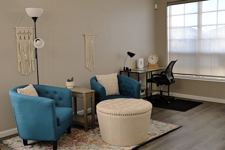 The living room has a dedicated work area and some comfy chairs where you can engage in conversation.