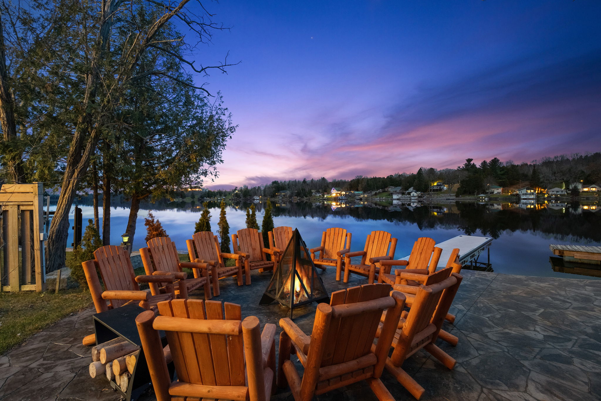 Lakeside firepit with rustic Adirondack seating for the whole group — unforgettable sunsets over the water.