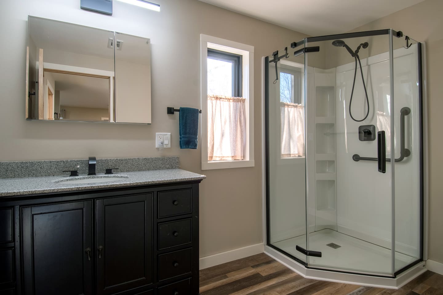 Guest Quarters bathroom has grab bars in the walk-in shower.