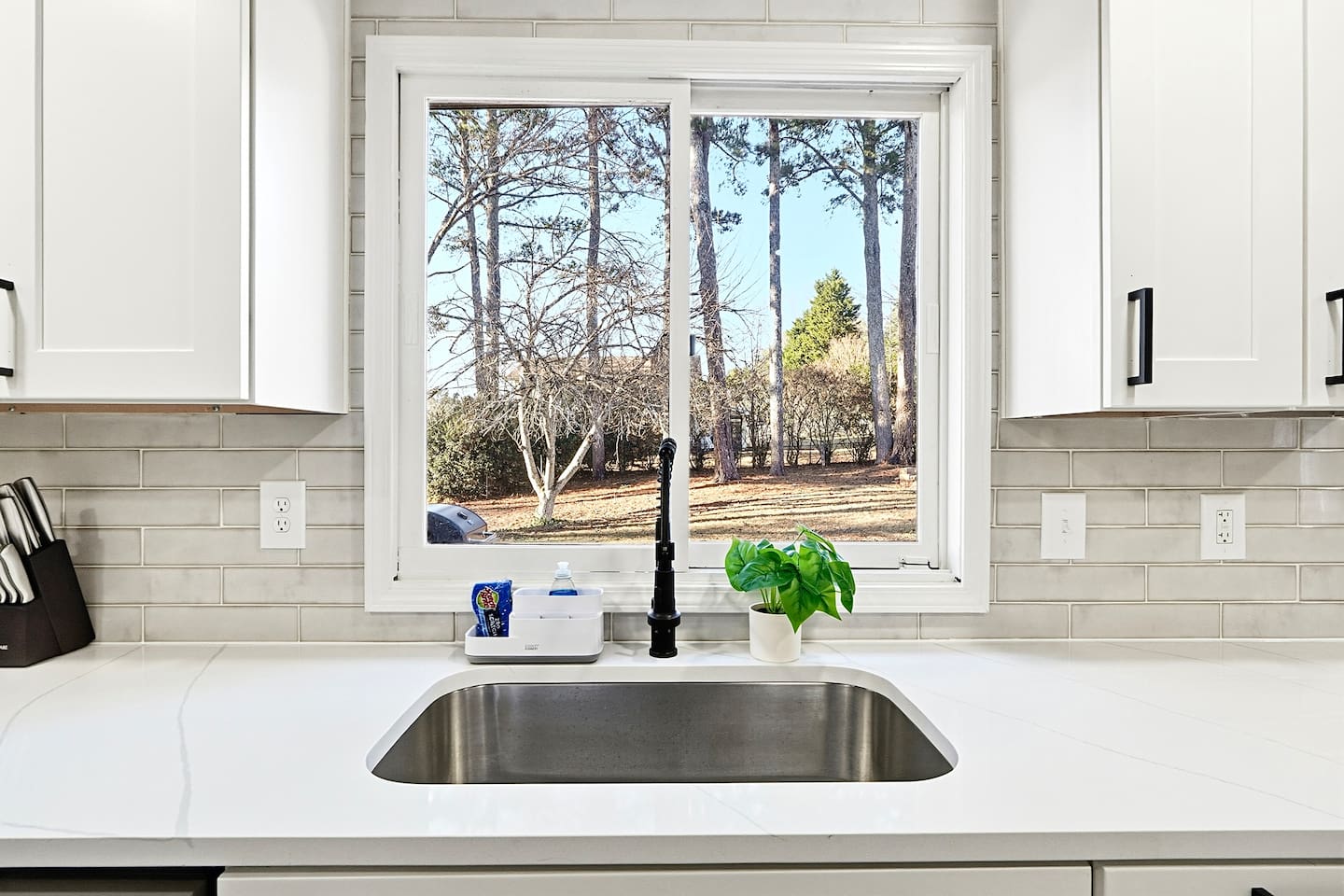 Bright white kitchen with a sleek, extended layout and ample counter space. The long layout offers plenty of countertop space, perfect for cooking, prepping, and everyday meals. Fully stocked with everything you need for a comfortable stay!
