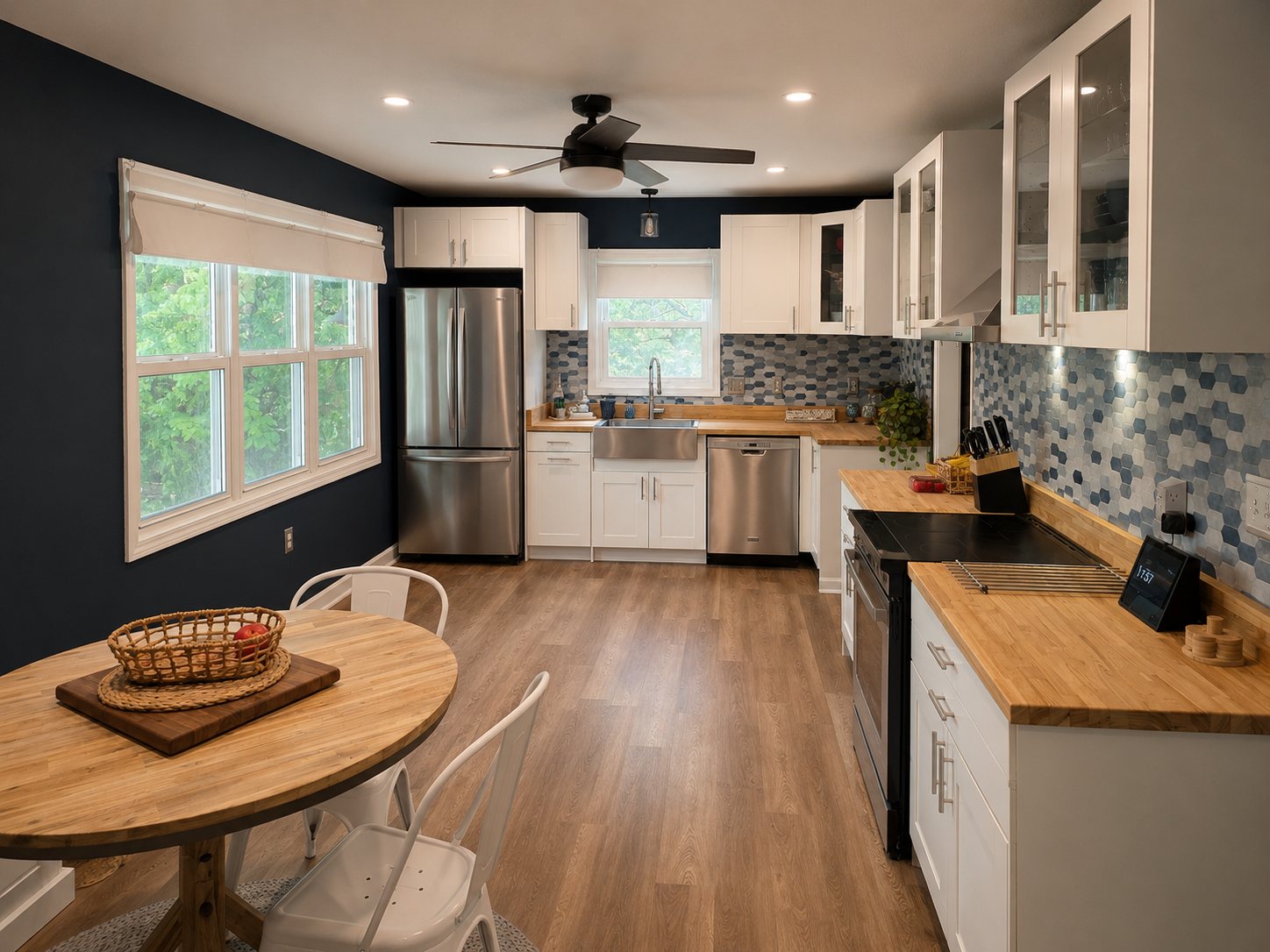 Bright open kitchen with butcher block countertops, stainless appliances and a casual dining table nearby.