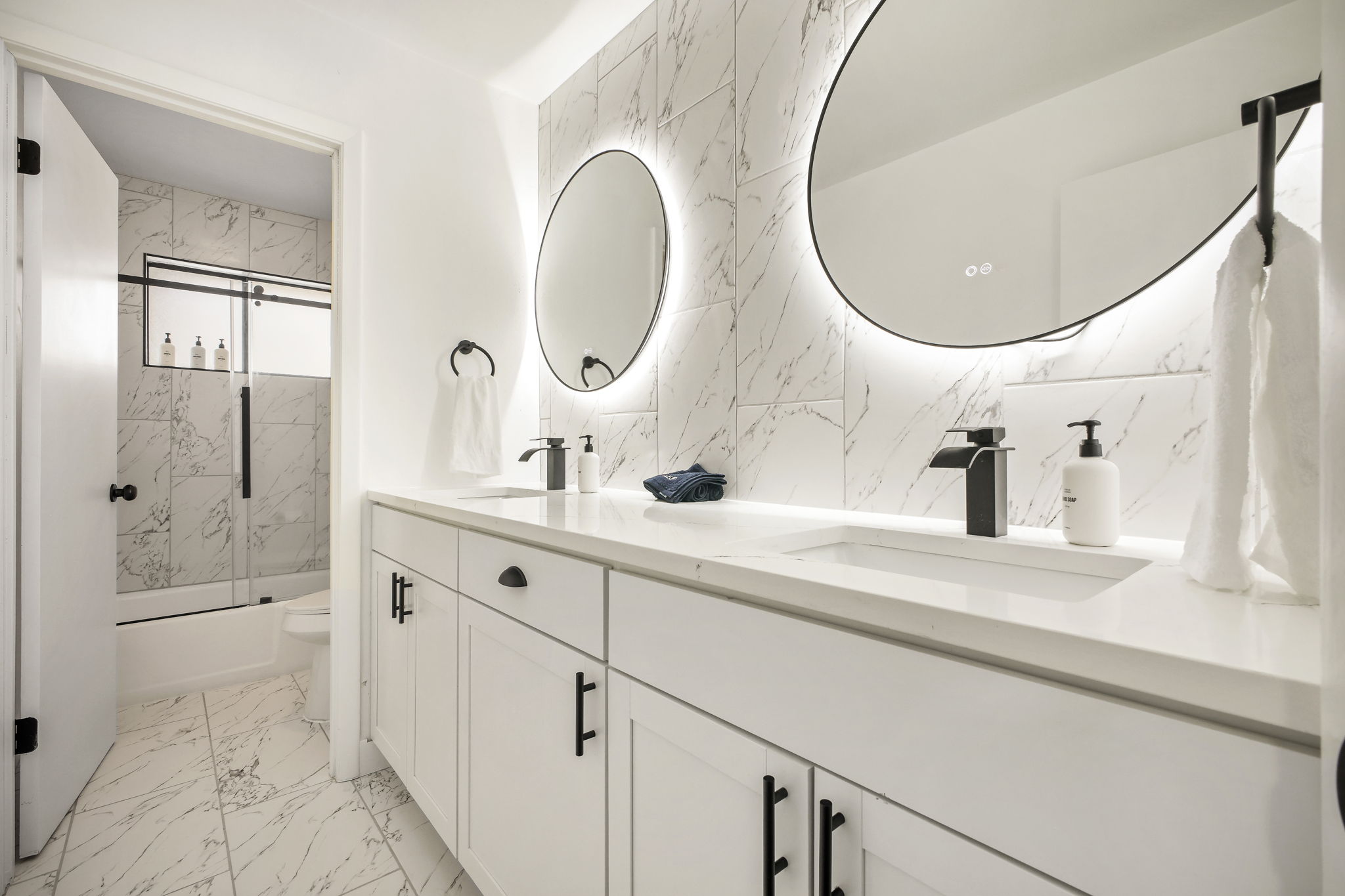 This bright upstairs bathroom is shared by the bedrooms & features spacious dual vanity, full-size tub, and shower. It’s clean, modern, & practical space designed for comfort & convenience.