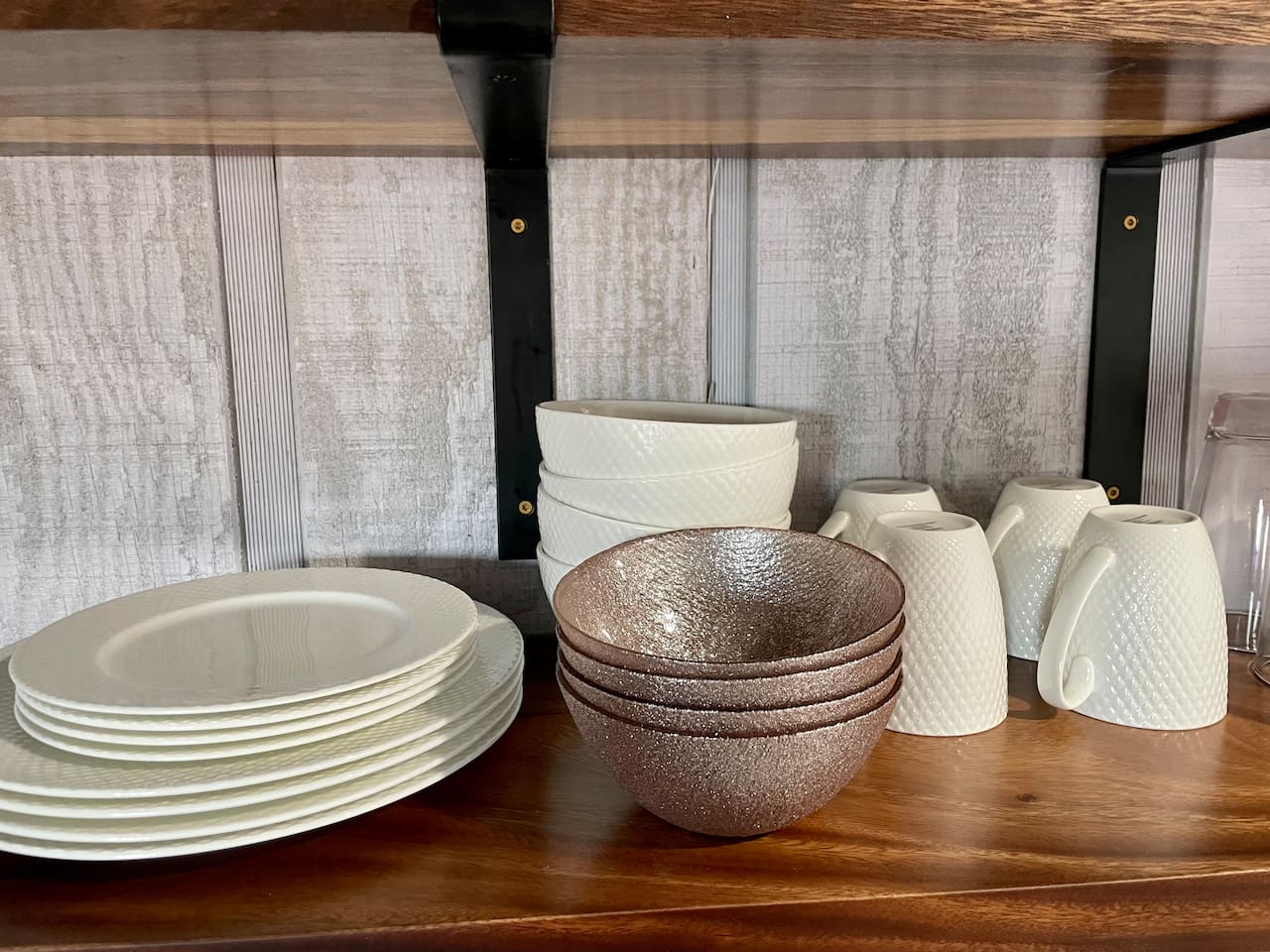 Dishes, basic cookware, and silverware are available in the kitchen/cooking space.