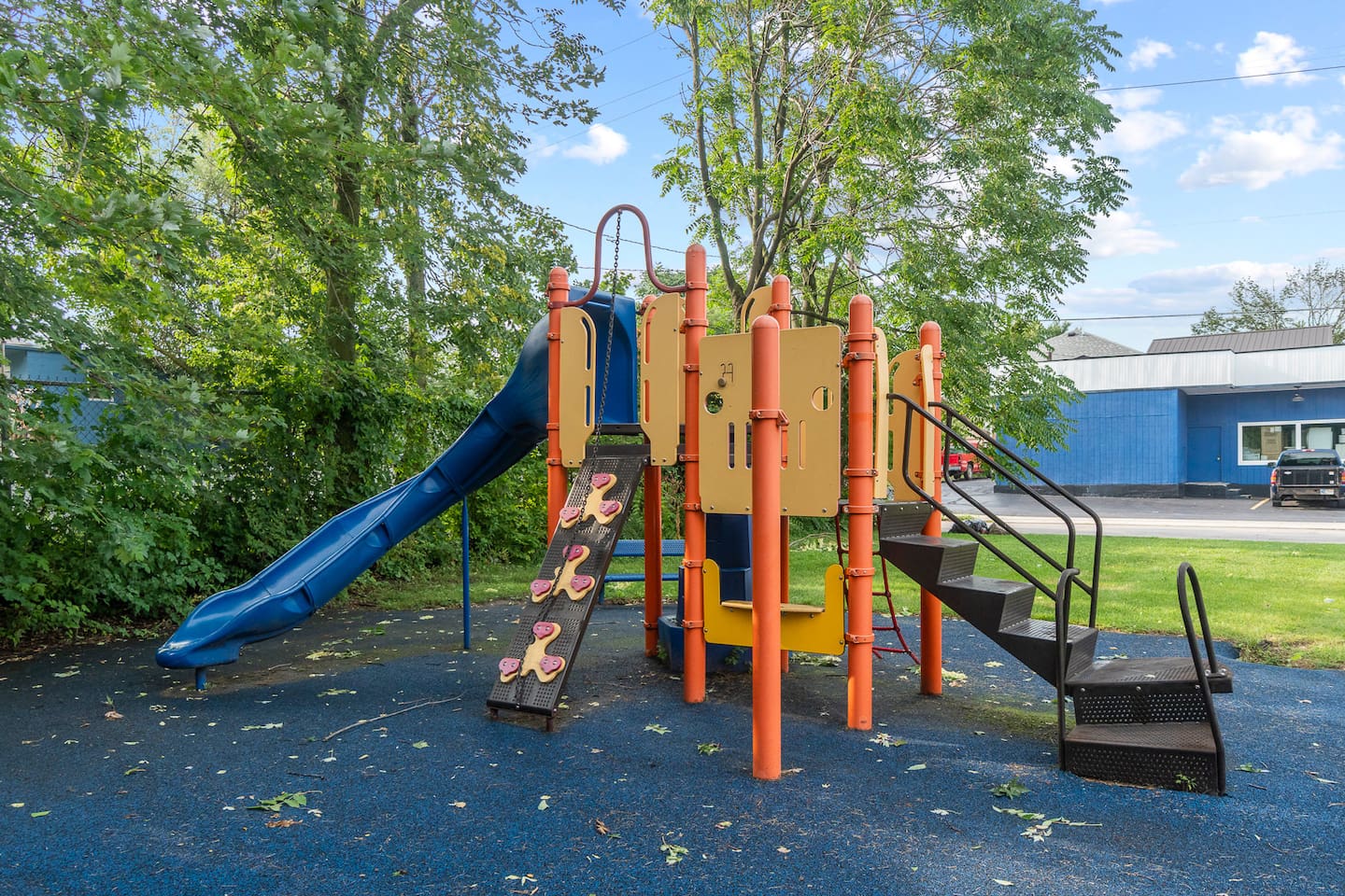 Playground slide and play structure steps away.