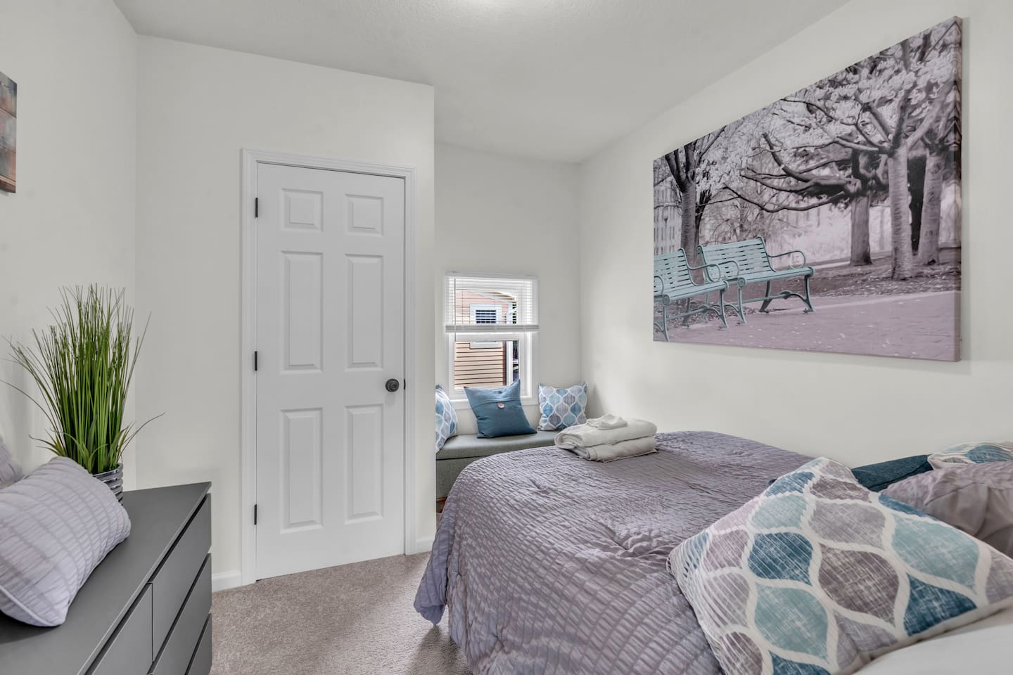 Relaxing bedroom with a scenic view through the window, bringing in natural light and a refreshing breeze.