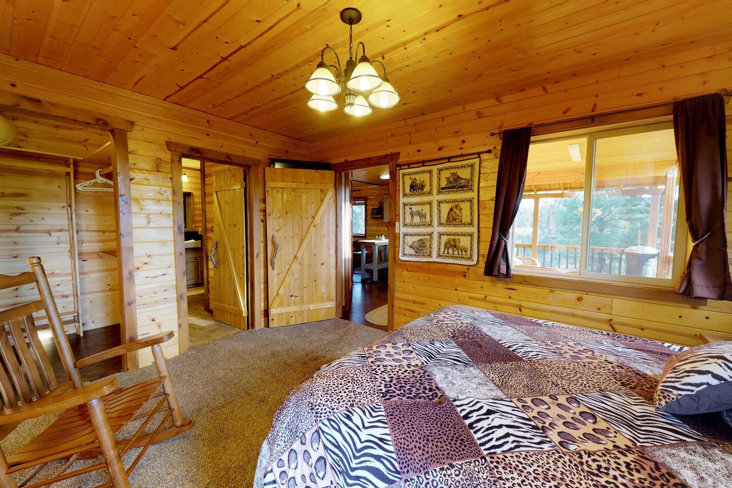The master bedroom attaches directly with the bathroom and features a queen sized bed.