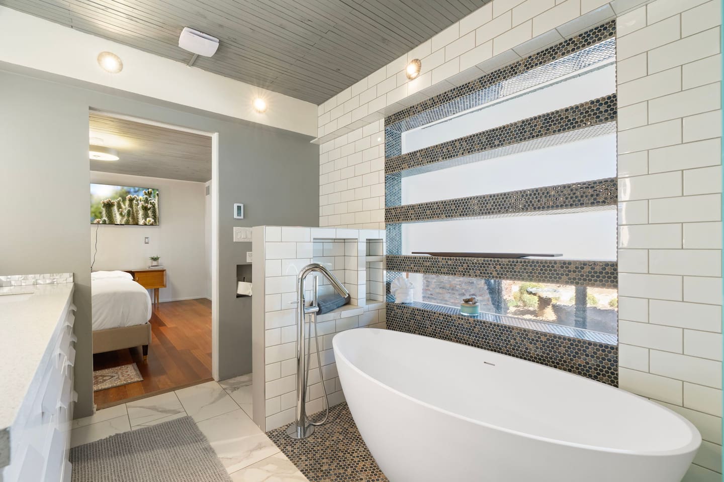 Spa-inspired bathroom featuring a sleek freestanding soaking tub, modern tile finishes, and a bright, airy design for ultimate relaxation.