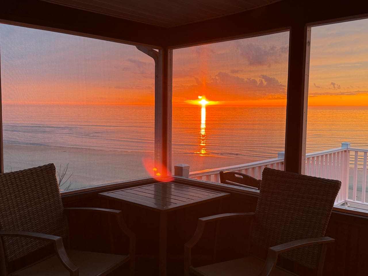Enjoy a stunning sunset from the comfort of this elegant screened-in porch. It provides the perfect luxury setting to relax and take in breathtaking, panoramic bay views.
