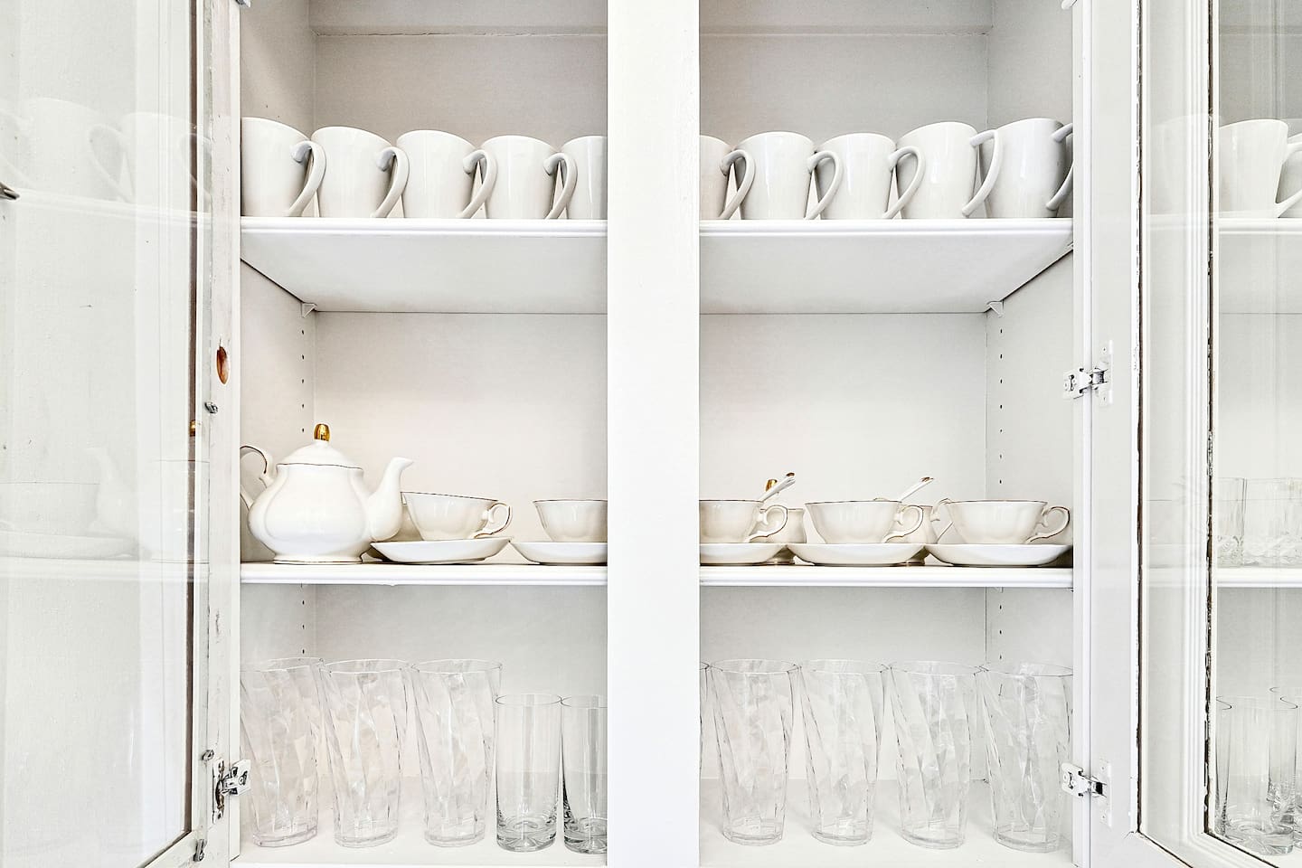 Bright and beautifully designed kitchen with white marble counters and white wood cabinetry. Fully equipped and ideal for cooking, gathering, and hosting with ease.