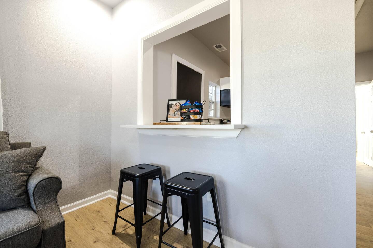 Bar seating on both sides of the kitchen window creates a perfect space for socializing while meals are prepared.