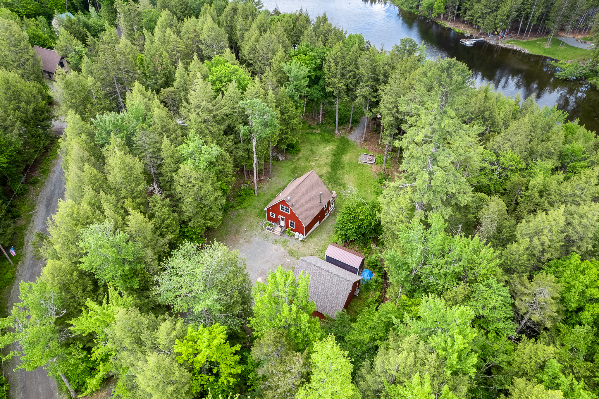 Private lake access with a dock in protected cove, large parking area, large backyard, quiet surroundings.