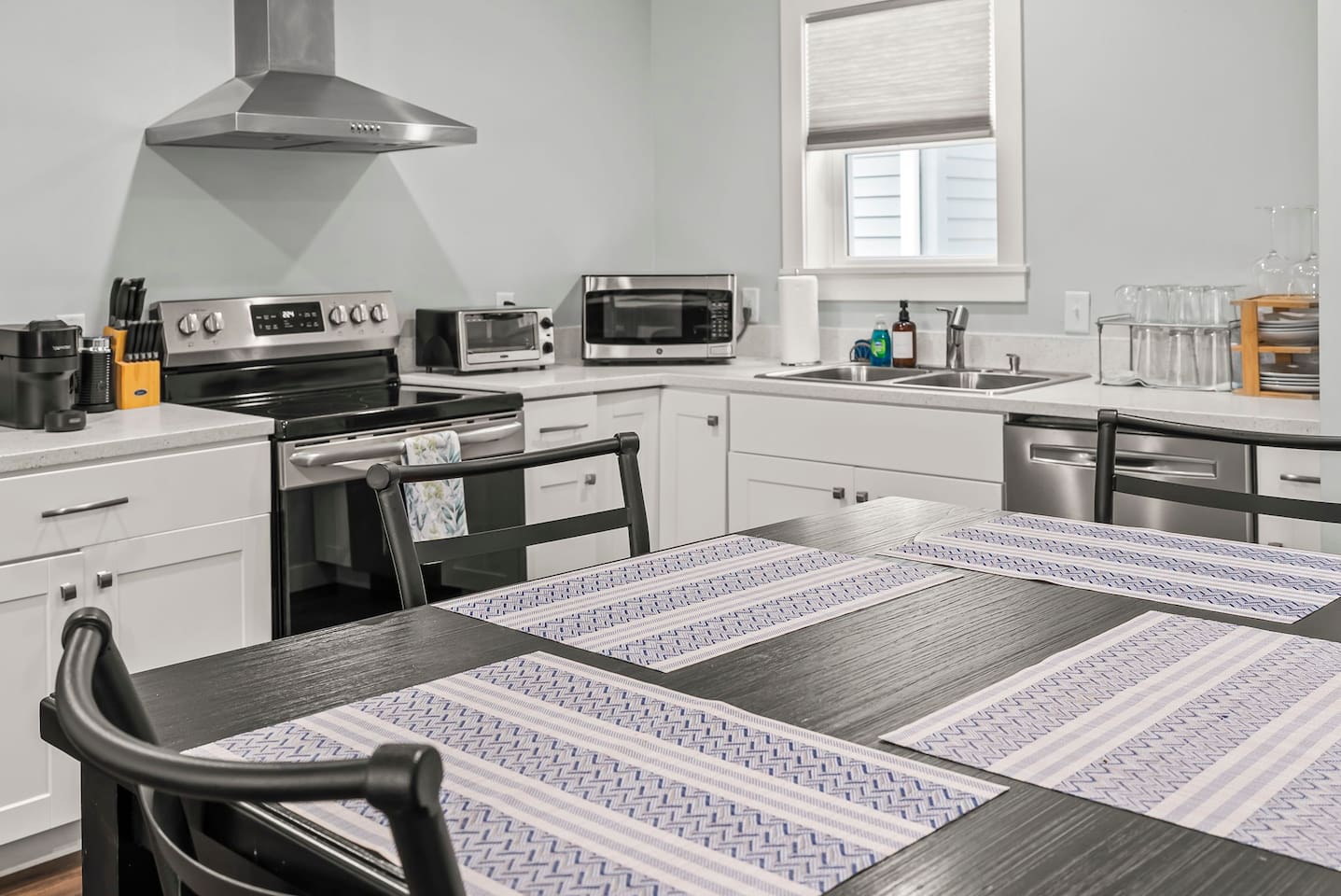 Close-up view of the dining table highlighting modern design and a welcoming setup for guests.
