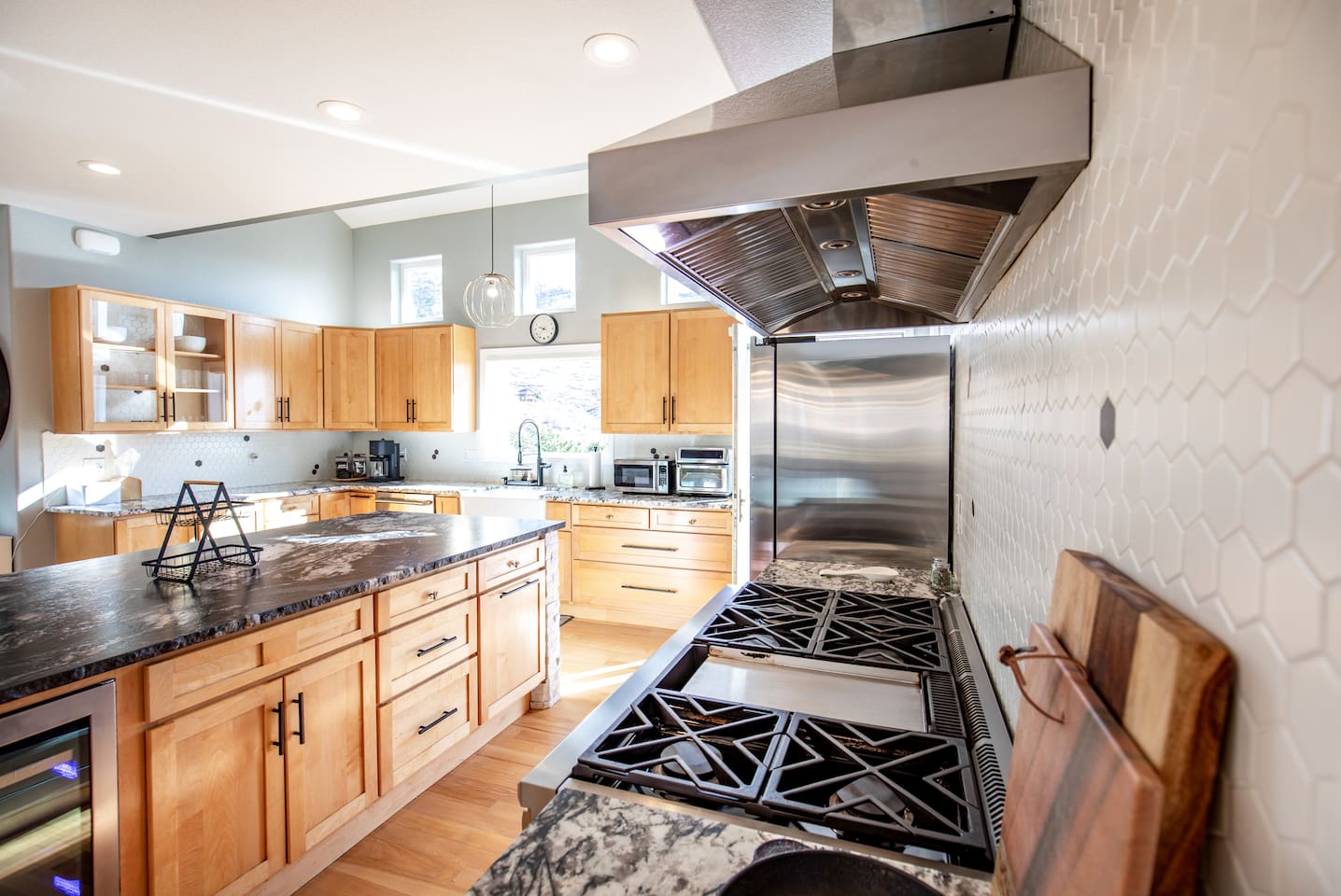 Cook like a pro on the sleek gas range with a stylish hood, perfect for preparing delicious meals in a modern kitchen.