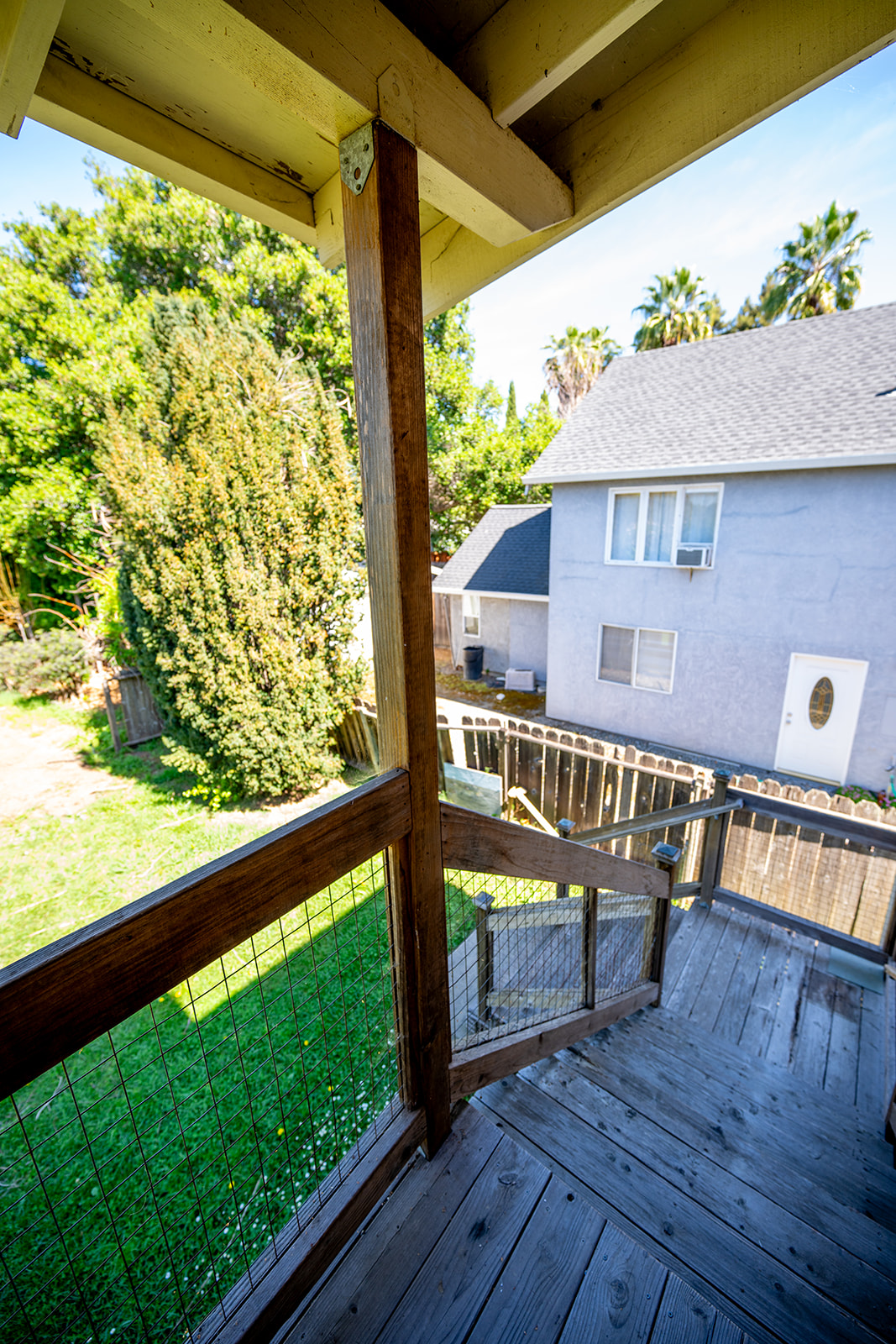 Back patio and stairs down to yard. 