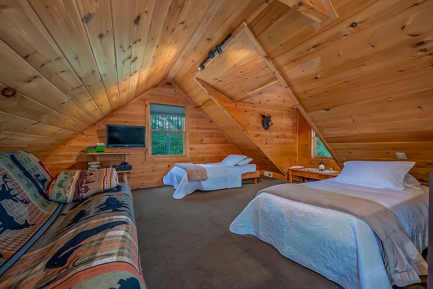 Upstairs loft bedroom with 2 twin beds and a queen futon sleeper and PlayStation.