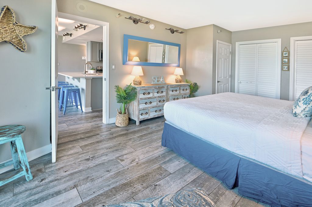 Rest up after a day in the sun in this plush, coastal-themed master suite.
