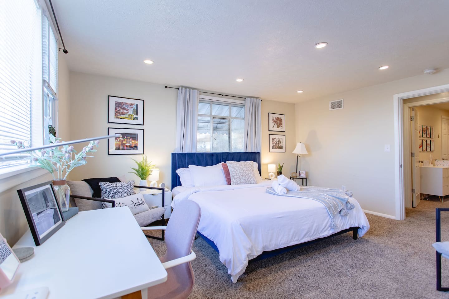 Cozy, spacious room with a queen-sized bed, TV, and a dedicated working space.