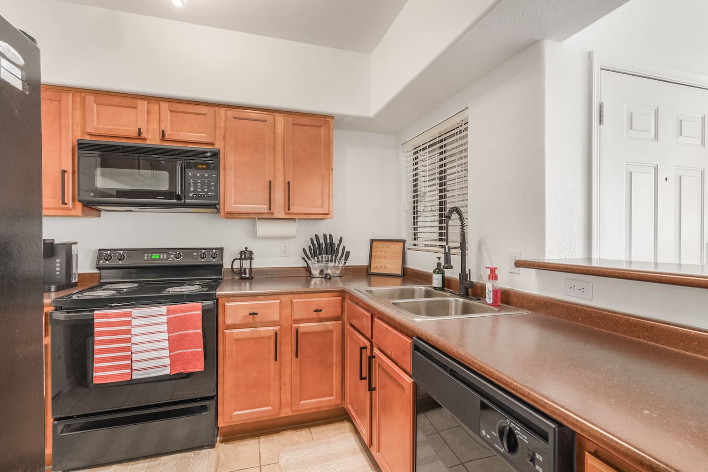   Kitchen with full-size fridge, stove, dishwasher, and plenty of counter space for daily use