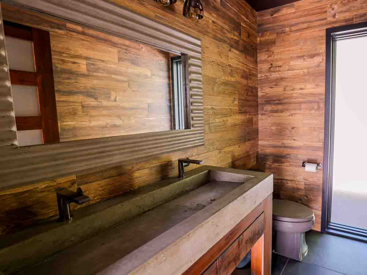 Cedar-walled bathroom with concrete double trough sink &mdash; Sunset Falls Restore