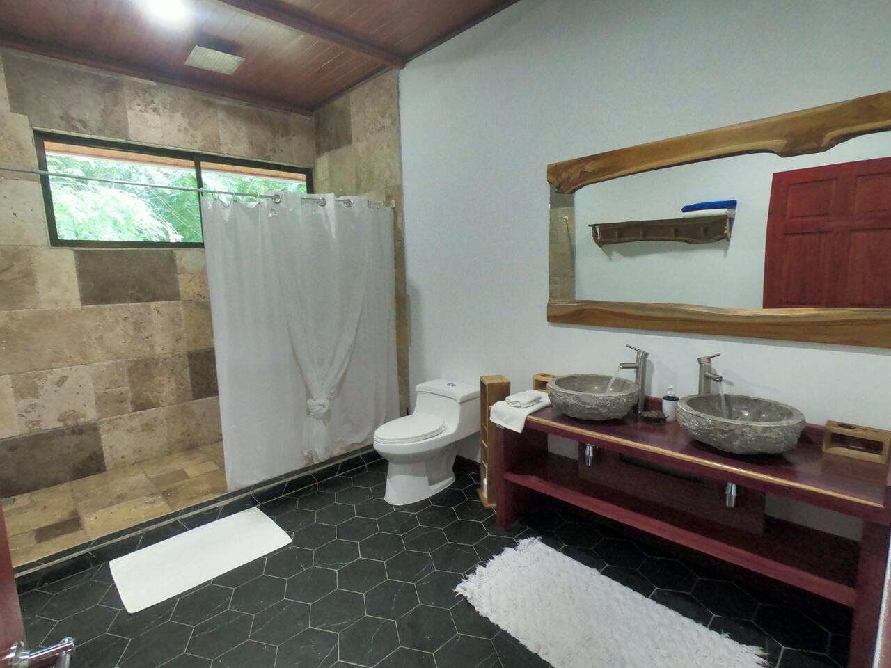 Spacious full bathroom with double sinks and large walk-in shower.