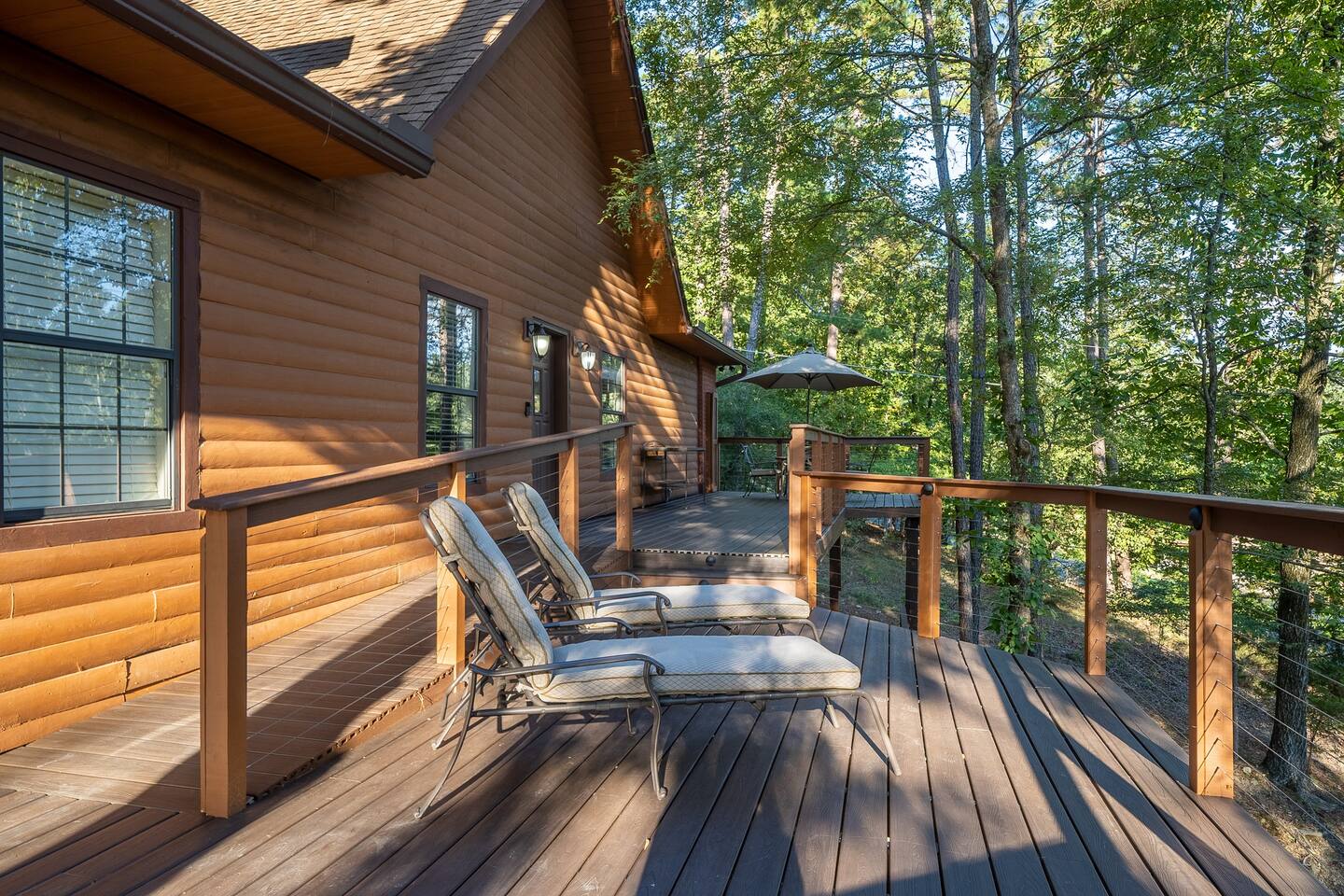 Get lost on this huge front deck with chaise loungers, a  dining table for 4 and a buffet for outdoor dining. The deck overlooks the Lake across the street  You are high up in the trees.  It is a great place to chill.  -Front Deck